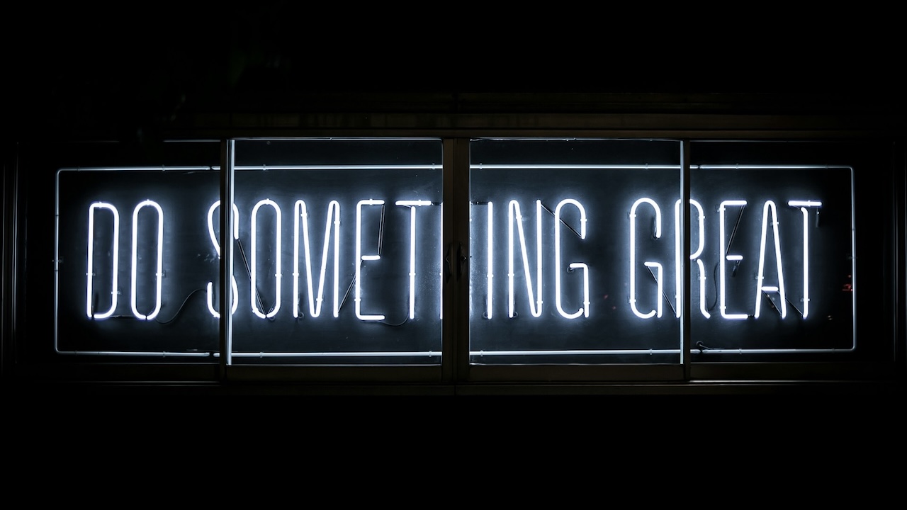 Black electronic sign with the wording do something great in white