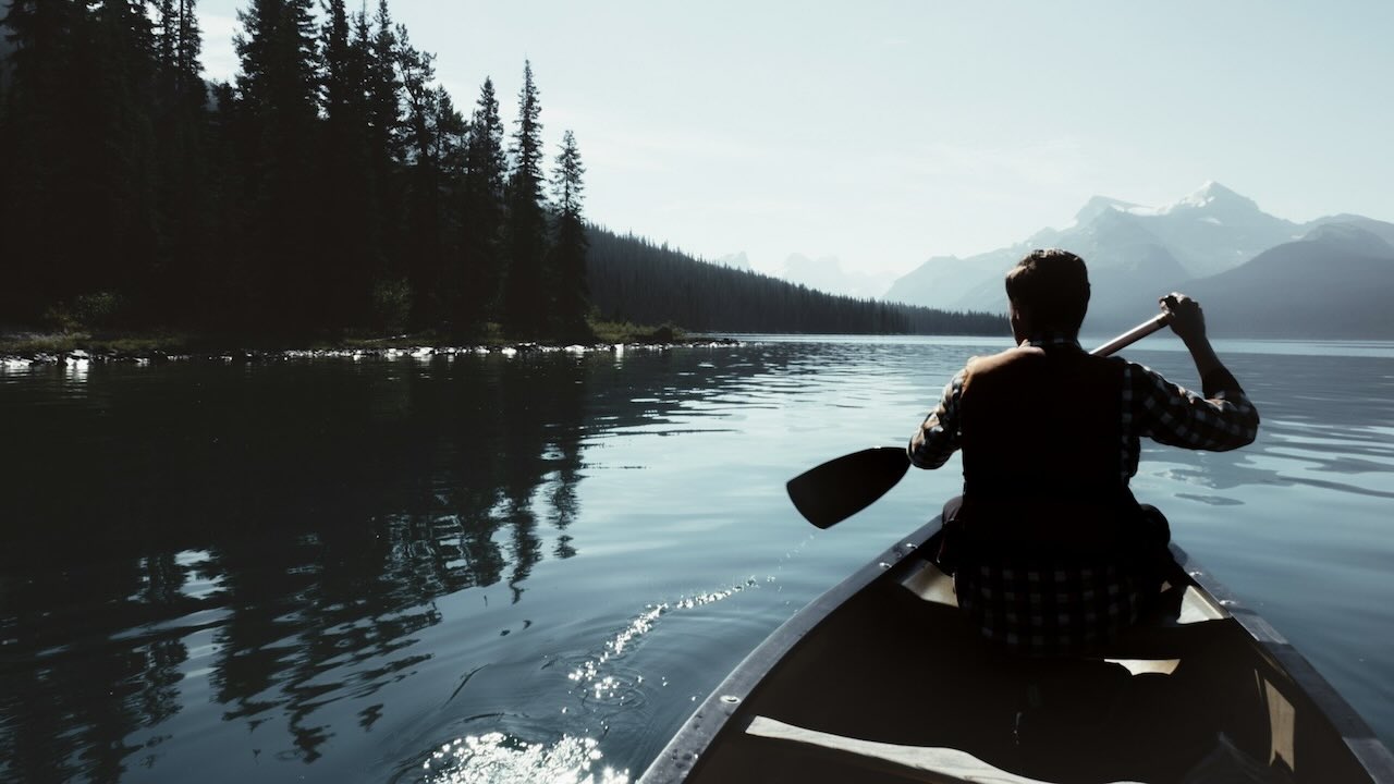 Man on a canoe exploring the winderness